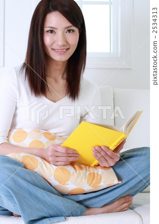 A woman reading a book A woman reading a book 2534313