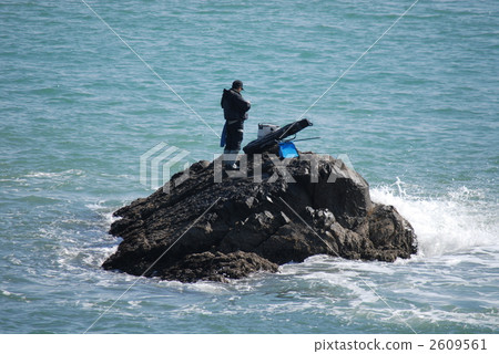 An angler preparing for a fishing boat at a rocky place on the Pacific Ocean 2609561