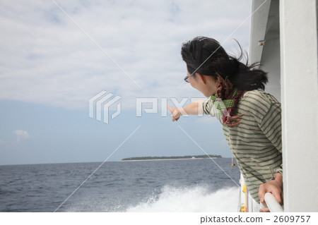 A girl watching a remote island from a ship 2609757