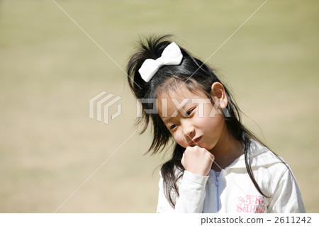 A girl thinking with a cheek stick 2611242