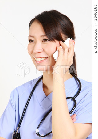 Female doctor smiling while speaking on smartphone Female doctor smiling while speaking on smartphone 2640169