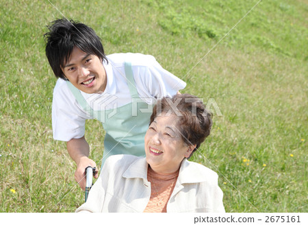 Wheelchair senior and helper Wheelchair senior and helper 2675161