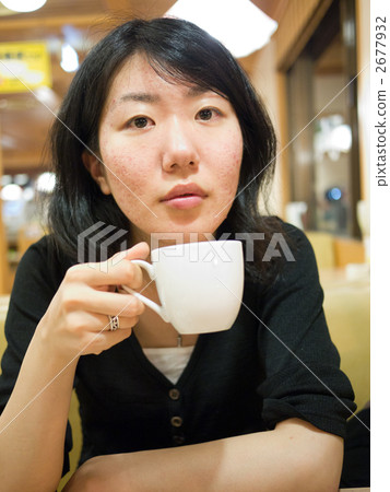 A woman holding a breath with coffee A woman holding a breath with coffee 2677932