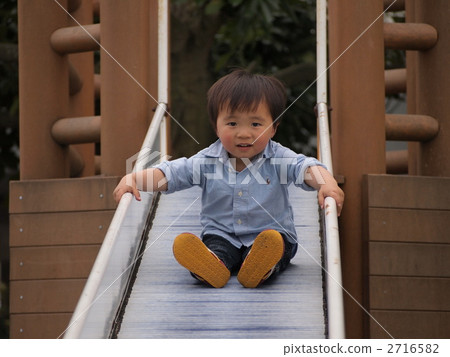 Boy playing on the slide Boy playing on the slide 2716582