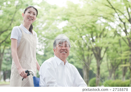 Senior and helper walking in the park 2718878