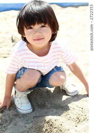 A boy playing in a sandbox A boy playing in a sandbox 2722355
