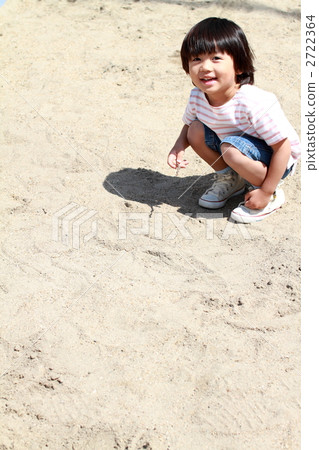 A boy playing in a sandbox 2722364