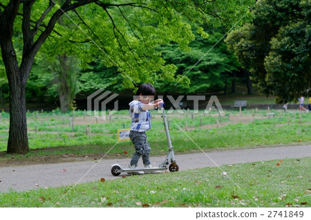 Kids riding a kickboard 2741849