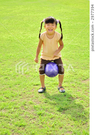 Girl playing balls on the lawn 2977394