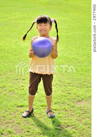 Girl playing balls on the lawn 2977400
