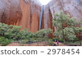 Waterfall is hit by Ayers Rock on rainy day 2978454