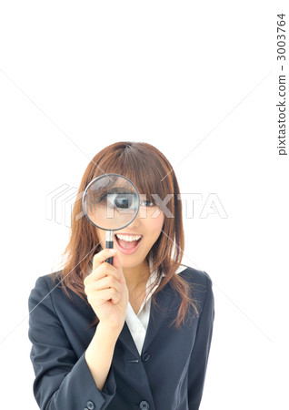 Business woman staring at here with a magnifying glass 3003764
