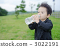 Three-year-old boys drinking water on the lawn 3022191