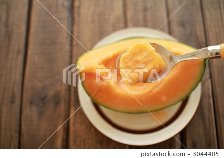 Fully ripe and fresh Hokkaido Yotei melon - Red flesh melon served with chopsticks Fully ripe and fresh Hokkaido Yotei melon - Red flesh melon served with chopsticks 3044405