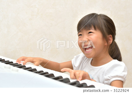 A girl playing the piano A girl playing the piano 3122924