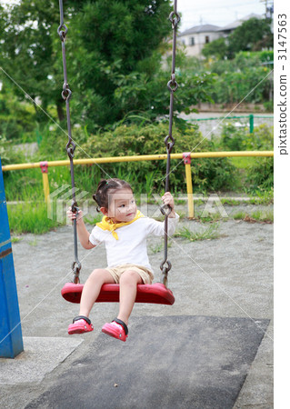 Two girls playing a swing 3147563
