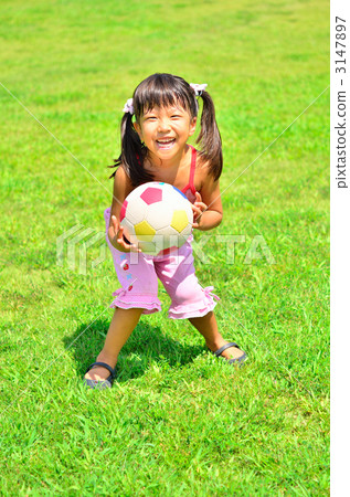 Girl playing balls on the lawn 3147897