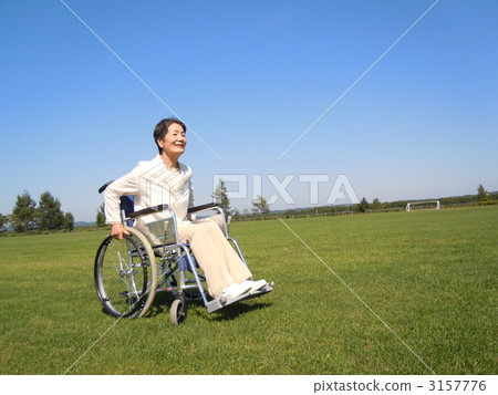 Senior women rubbing a wheelchair Senior women rubbing a wheelchair 3157776