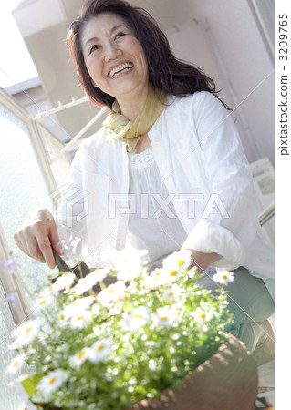 Senior women enjoying gardening on the veranda 3209765