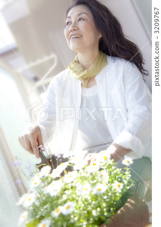 Senior women enjoying gardening on the veranda 3209767