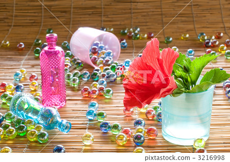 Hibiscus and glass bottles and marbles 3216998