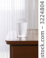 Water in the glass above the desk 3224804