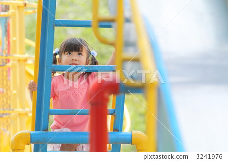 Girls playing with park play equipment 3241976