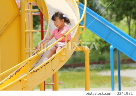 Young Girl Sliding Down A Playground Slide In Summer Stock Photo, Picture  and Royalty Free Image. Image 5760566.