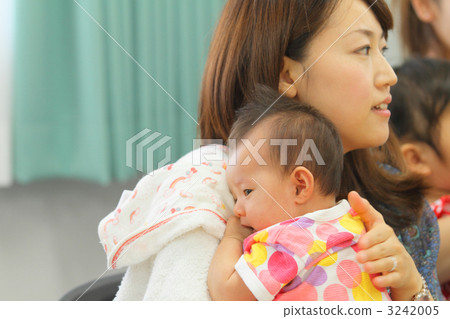 Mama holding a baby 2 months old after birth 3242005