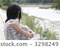 A girl who thinks hard on the river side 3298249