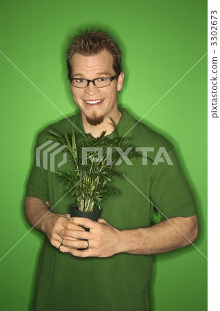 Man holding plant. Man holding plant. 3302673