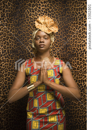 Young African American Woman Praying and Wearing Traditional African Dress 3302801