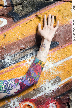 Tattooed woman's arm. Tattooed woman's arm. 3305900