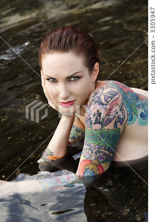 Sexy nude tattooed woman. Sexy nude tattooed woman. 3305947