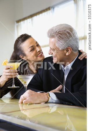 Couple drinking at bar. Couple drinking at bar. 3310375