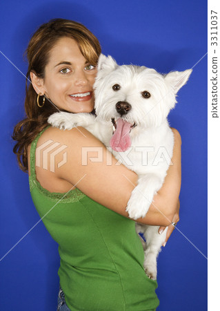 Woman holding white terrier dog. Woman holding white terrier dog. 3311037