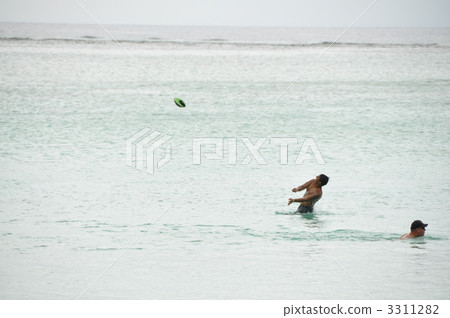 Frisbee at Matapan Pan Beach in Guam Frisbee at Matapan Pan Beach in Guam 3311282