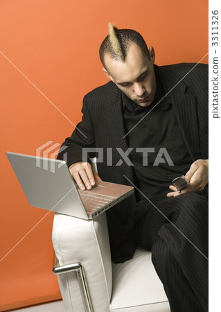 Businessman on laptop and cellphone. Businessman on laptop and cellphone. 3311326