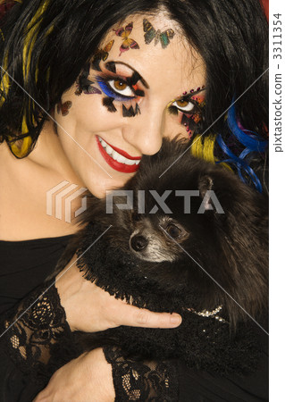 Woman holding Pomeranian dog. 3311354