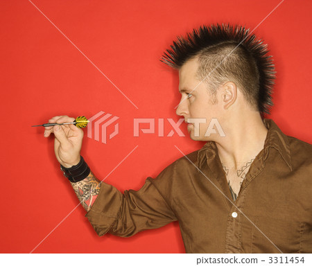 Caucasian man playing darts. 3311454