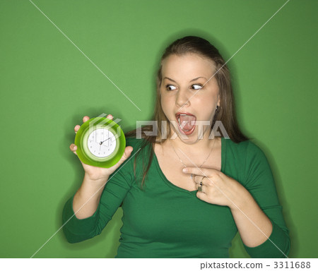Woman pointing to clock. 3311688