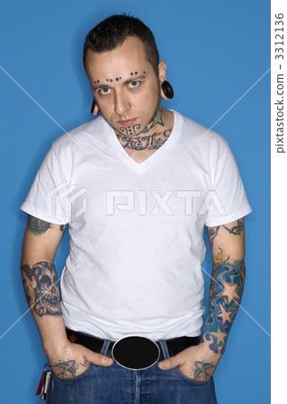 Man with tattoos and piercings. 3312136