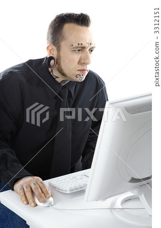 Tattooed man on computer. 3312151