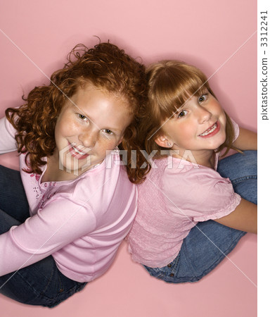 Girls sitting back to back. 3312241