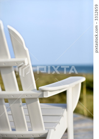 Adirondack chairs pointing toward ocean. Adirondack chairs pointing toward ocean. 3312659