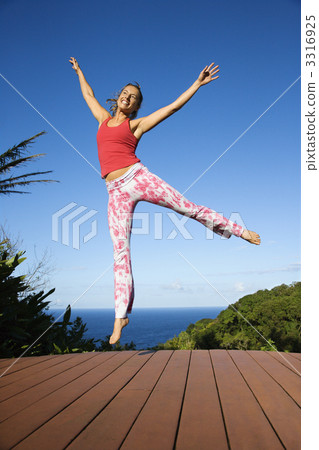 Woman jumping into air. 3316925