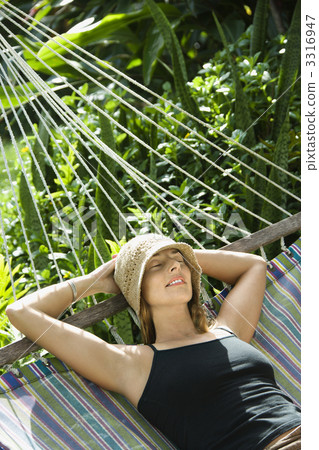 Woman relaxing in hammock. Woman relaxing in hammock. 3316947