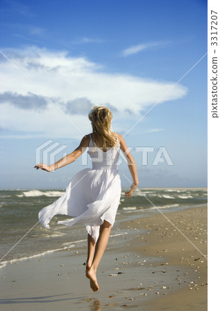Girl running down the beach. Girl running down the beach. 3317207