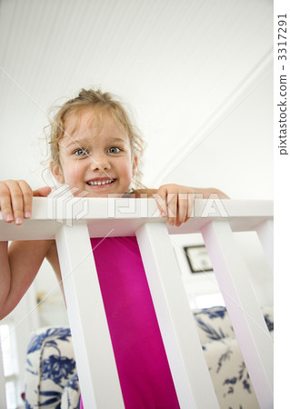 Girl peeking over railing. 3317291