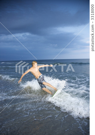 Boy riding skimboard. Boy riding skimboard. 3318000